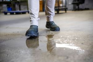 pedestrian walking over wet pavement